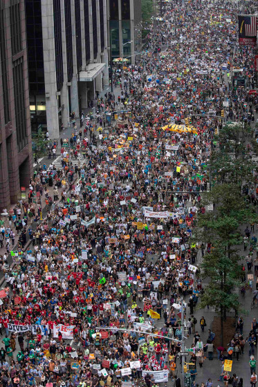 Tens of thousands march down 6th Avenue while taking part in the People's Climate March through Midtown, New York