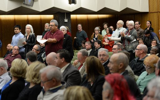 Andres Soto, holding papers, of Communities for a Better Environment, and others stand at the Contra Costa County Board of Supervisors meeting in Martinez, Calif., on Tuesday, Feb. 3, 2015. Opponents and proponents of a propane and butane recovery project at the Phillips 66 refinery in Rodeo made their feelings known as the board ponders an appeal of a land use permit for the project and considers the Environmental Impact Report as well. (Dan Honda/Bay Area News Group)