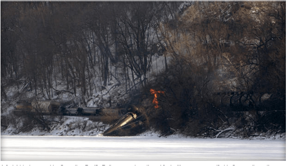 A freight train owned by Canadian Pacific Railway carrying ethanol fuel with one car engulfed in flames sits on the banks of the Mississippi River in a remote location north of Dubuque, Iowa, Feb. 4, 2015, in this picture provided by the Dubuque Telegraph Herald.  MIKE BURLEY/DUBUQUE TELEGRAPH HERALD/HANDOUT VIA REUTERS